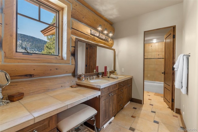 bathroom featuring vanity, tile patterned floors, and tiled shower / bath