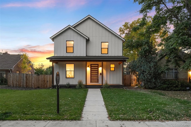 modern inspired farmhouse featuring a yard and covered porch