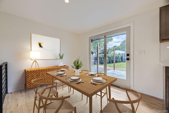 dining space featuring light wood-type flooring