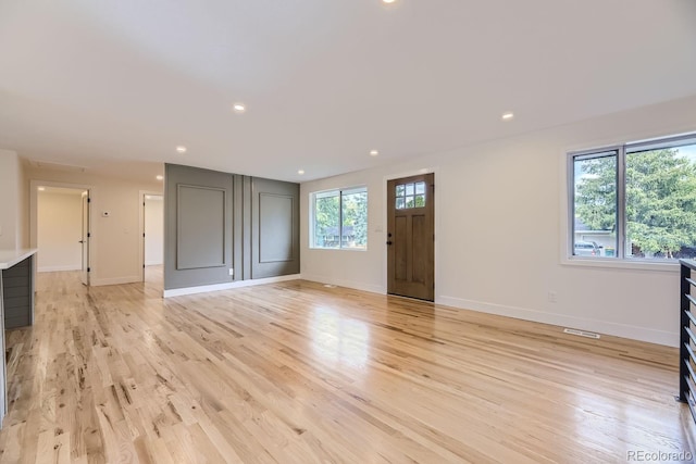 interior space featuring light hardwood / wood-style floors and a healthy amount of sunlight