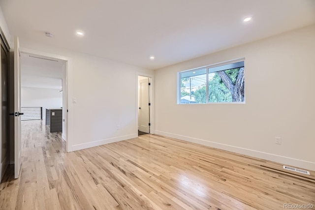 spare room featuring light wood-type flooring