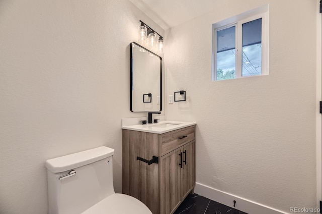 bathroom with toilet, tile patterned flooring, and vanity