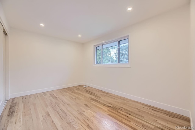 unfurnished room featuring light hardwood / wood-style floors