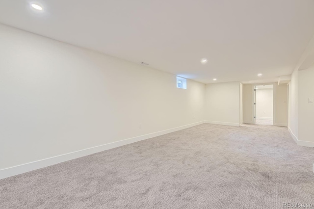 unfurnished room with light carpet