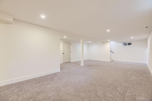 basement featuring light carpet