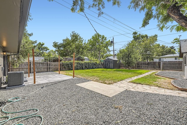 view of yard featuring a storage unit, a patio, and central AC unit