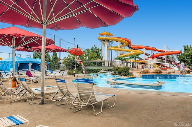 view of pool with a jacuzzi and a water slide