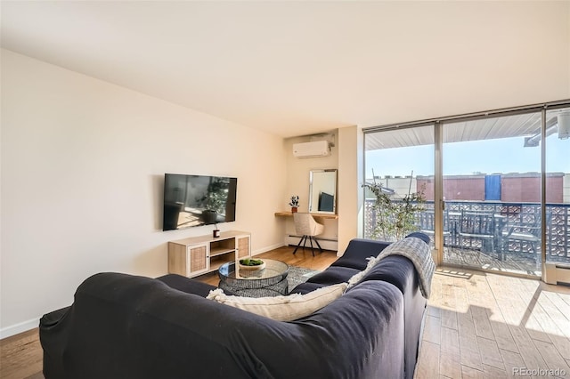 living room with a baseboard radiator, an AC wall unit, floor to ceiling windows, and hardwood / wood-style floors