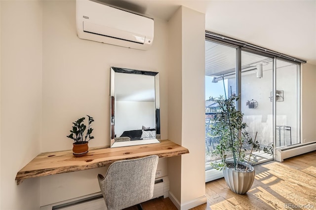 home office featuring floor to ceiling windows, wood-type flooring, a wall mounted AC, built in desk, and a baseboard radiator