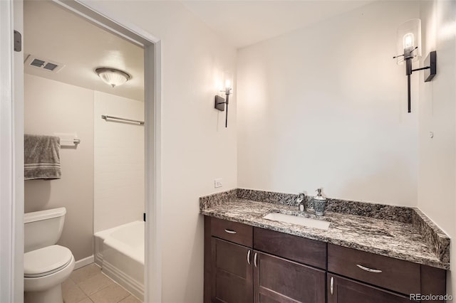 bathroom featuring vanity, tile patterned floors, and toilet