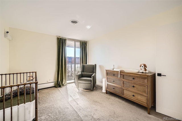 carpeted bedroom featuring a baseboard radiator