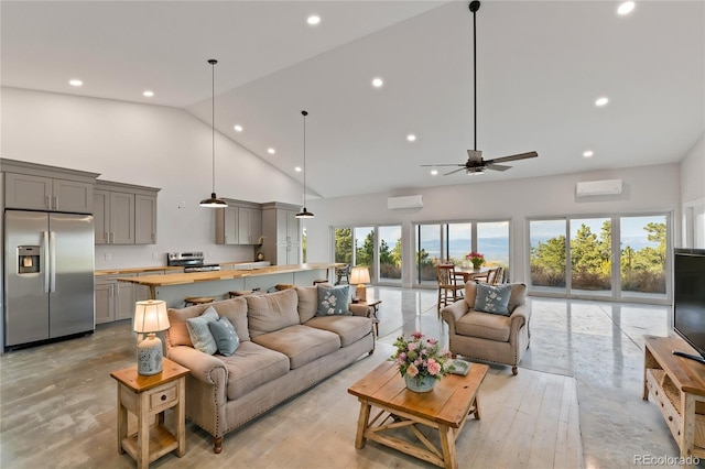 living room featuring light hardwood / wood-style flooring, a wall mounted AC, high vaulted ceiling, and ceiling fan