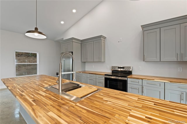 kitchen featuring hanging light fixtures, stainless steel electric stove, sink, gray cabinets, and butcher block countertops