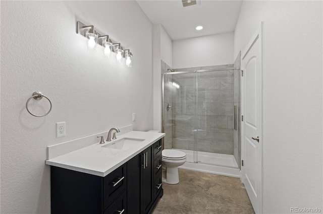 bathroom featuring toilet, a shower with shower door, and vanity