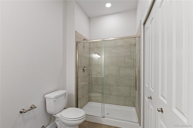 bathroom featuring toilet and walk in shower