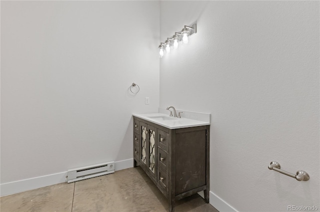 bathroom with baseboard heating, vanity, and concrete flooring