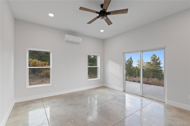 unfurnished room with ceiling fan, an AC wall unit, and a wealth of natural light