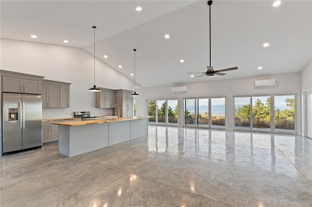 kitchen featuring gray cabinetry, high vaulted ceiling, appliances with stainless steel finishes, and wooden counters