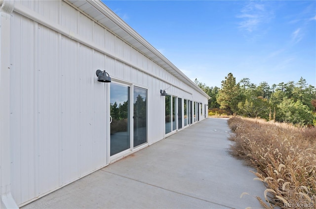 view of side of home with a patio area