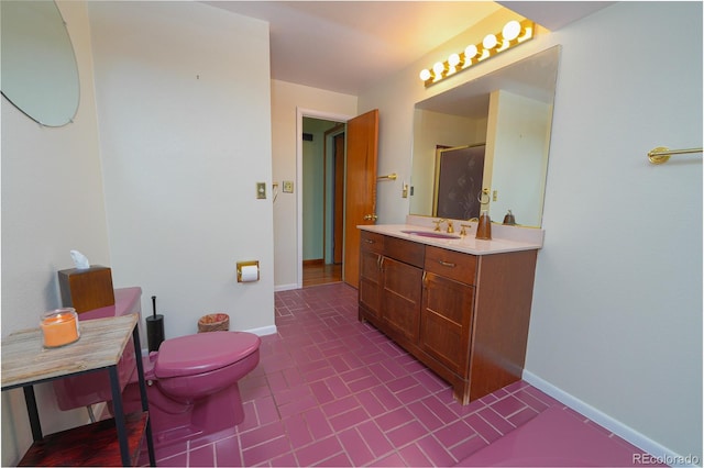 bathroom featuring vanity, walk in shower, and toilet