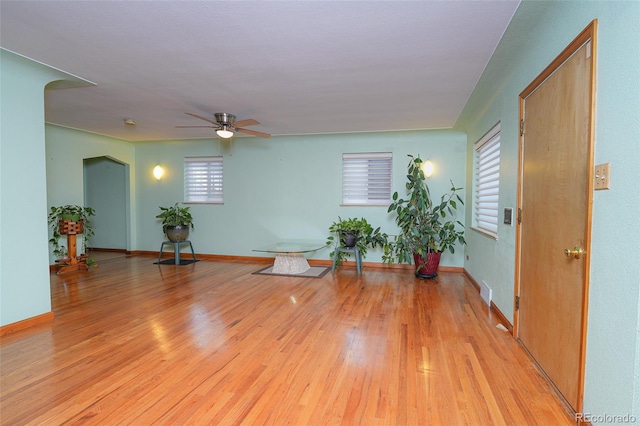 foyer entrance with ceiling fan and light hardwood / wood-style flooring