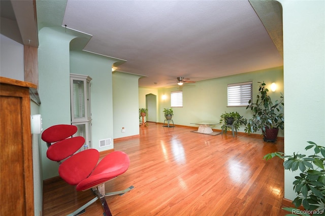 sitting room featuring hardwood / wood-style floors, a textured ceiling, and ceiling fan