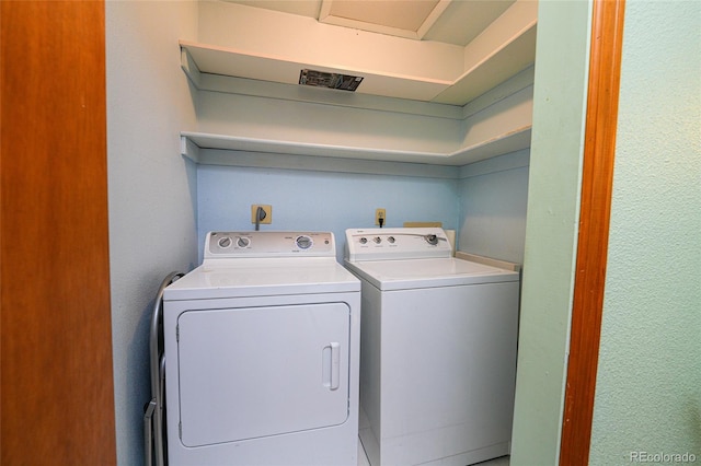 clothes washing area with independent washer and dryer