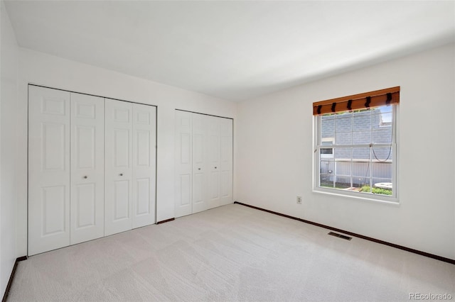 16 Scott Dr N, Broomfield, CO 80020 - unfurnished bedroom featuring two closets and light colored carpet