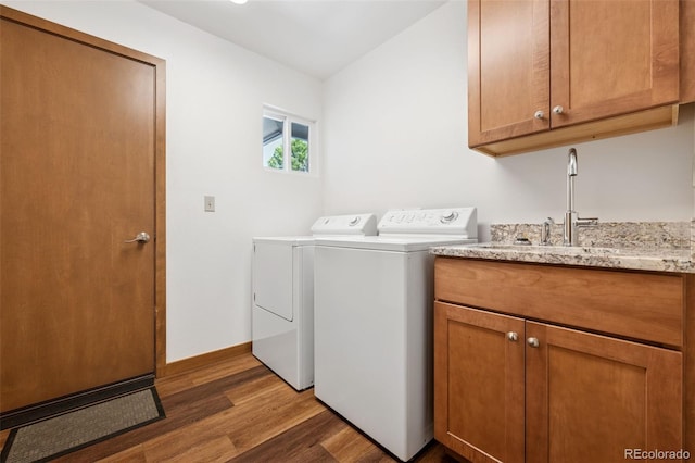 16 Scott Dr N, Broomfield, CO 80020 - laundry area with independent washer and dryer, cabinet space, and wood finished floors