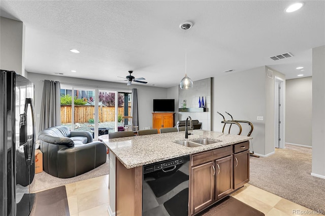 9635 Bellaire Ln, Thornton, CO 80229 - kitchen featuring a sink, black appliances, open floor plan, light stone counters, and recessed lighting