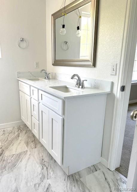 12225 E 2nd Dr, Aurora, CO 80011 - bathroom with double vanity and marble look tiles