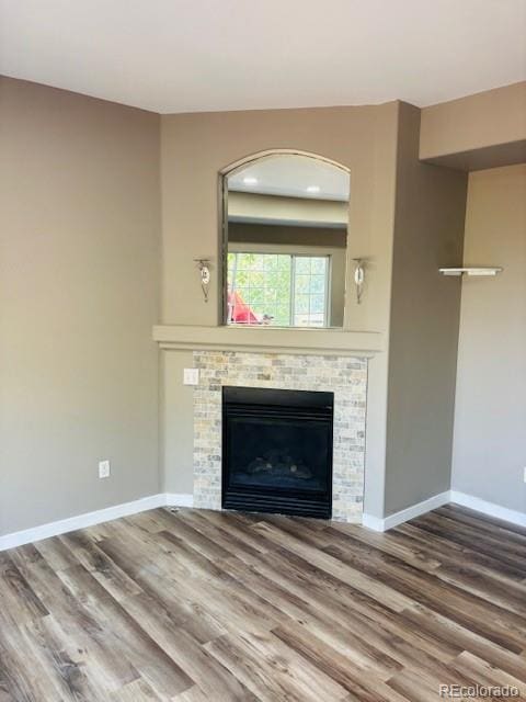 12225 E 2nd Dr, Aurora, CO 80011 - unfurnished living room featuring wood finished floors and a glass covered fireplace