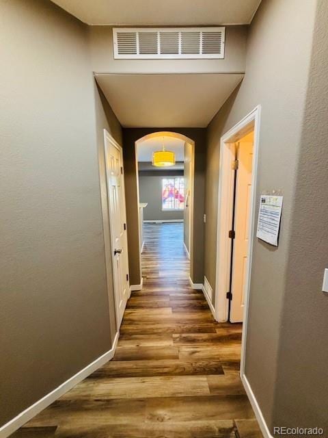 12225 E 2nd Dr, Aurora, CO 80011 - corridor featuring wood finished floors and arched walkways
