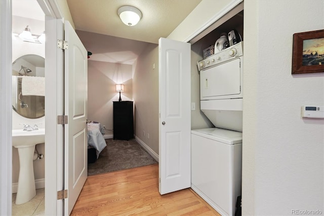 620 11th St Unit 206, Golden, CO 80401 - laundry room featuring stacked washing machine and dryer and light wood-style floors
