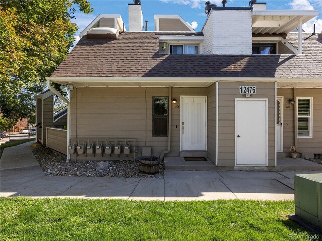 12476 W Nevada Pl Unit 106, Lakewood, CO 80228 - multi unit property featuring roof with shingles, a chimney, and a patio area