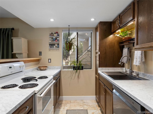 12476 W Nevada Pl Unit 106, Lakewood, CO 80228 - kitchen featuring white range with electric stovetop, a sink, stainless steel dishwasher, light countertops, and baseboards