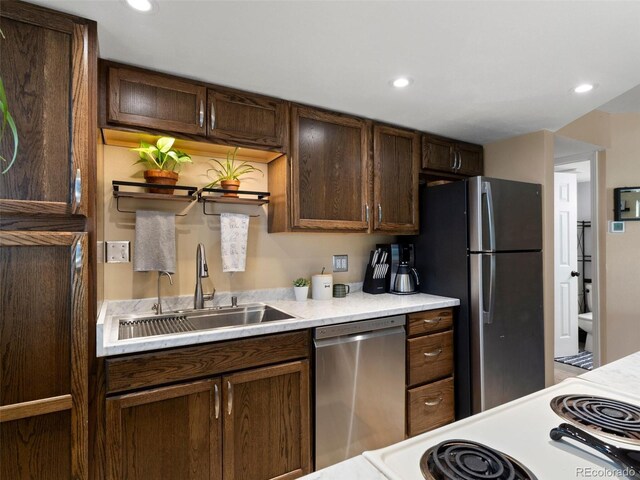 12476 W Nevada Pl Unit 106, Lakewood, CO 80228 - kitchen featuring stainless steel appliances, a sink, light countertops, dark brown cabinetry, and recessed lighting
