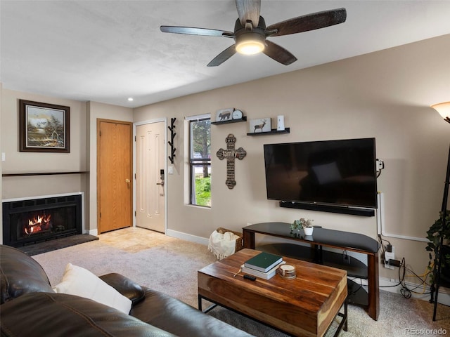 12476 W Nevada Pl Unit 106, Lakewood, CO 80228 - living room featuring baseboards, light carpet, ceiling fan, and a warm lit fireplace