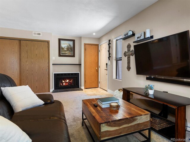 12476 W Nevada Pl Unit 106, Lakewood, CO 80228 - carpeted living room with a warm lit fireplace and baseboards