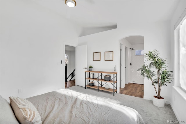 bedroom featuring vaulted ceiling and carpet