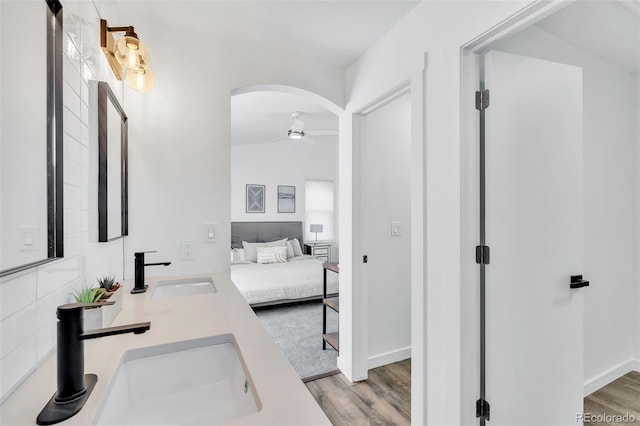 bathroom with wood-type flooring, vanity, and ceiling fan