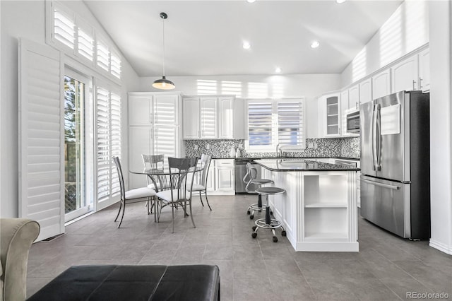 kitchen with pendant lighting, a center island, white cabinets, and appliances with stainless steel finishes