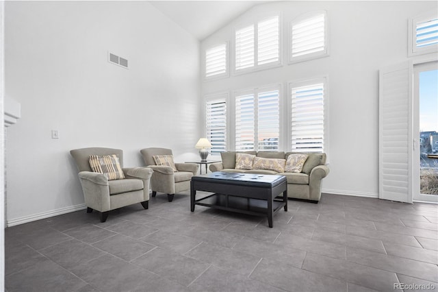 tiled living room with high vaulted ceiling