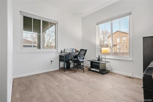 office area with light hardwood / wood-style floors