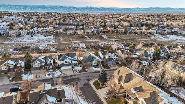 snowy aerial view featuring a mountain view