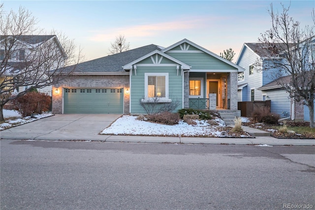 view of front of house with a porch and a garage