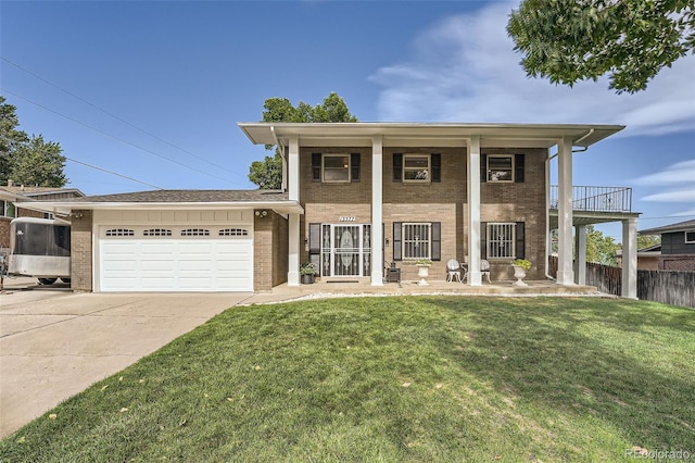 view of front of house with a garage, a front lawn, and a balcony