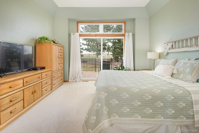 bedroom featuring light carpet, access to exterior, and lofted ceiling