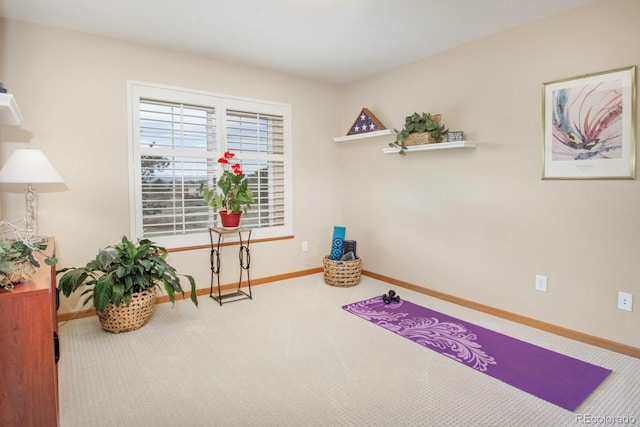 living area featuring carpet flooring and baseboards