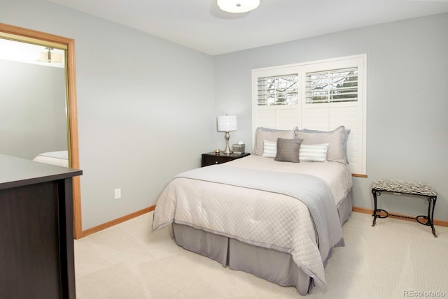 bedroom featuring baseboards and light carpet